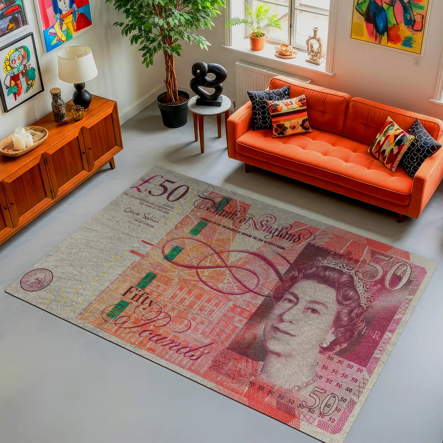 Living room with an orange sofa and a large £50 banknote rug.