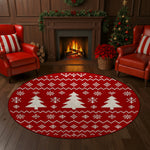 Living room with a red round rug featuring white Christmas tree patterns, two red chairs, a fireplace, and a Christmas tree.

