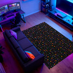 Colorful patterned rug on a wooden floor with gaming setup in the background