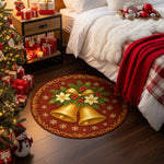 Decorative Christmas rug with bells on a wooden floor next to a bed and Christmas tree.

