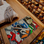 Colorful rug on a wooden floor with a shoe rack in the background

