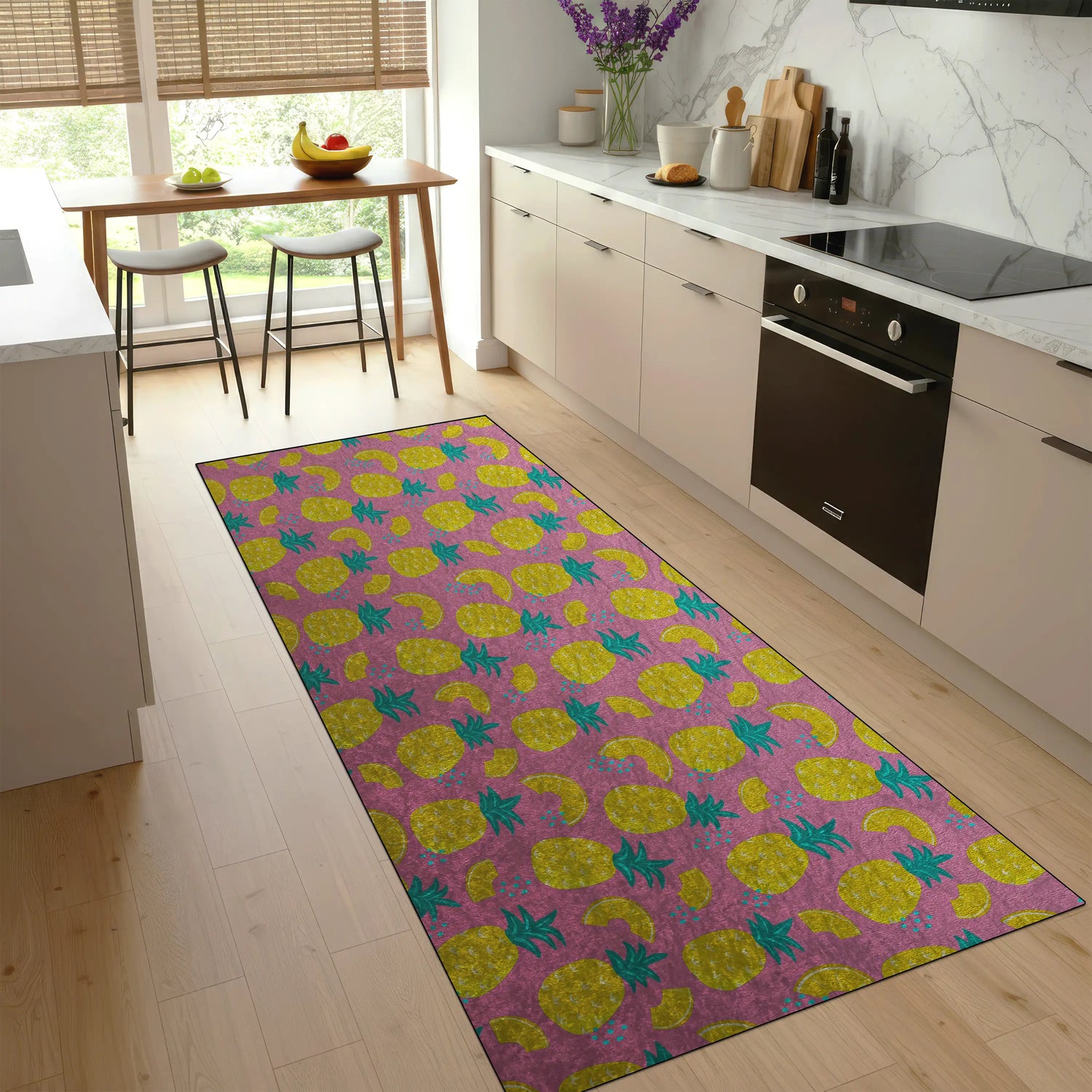 Colorful pineapple-patterned rug on a wooden floor in a modern kitchen.