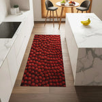 Red patterned rug on a wooden floor in a modern kitchen.