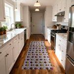 Modern kitchen with a patterned rug on wooden flooring