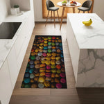 Colorful macaron pattern rug on a wooden floor in a modern kitchen.