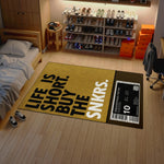 Room with a yellow rug featuring text and a sneaker display.

