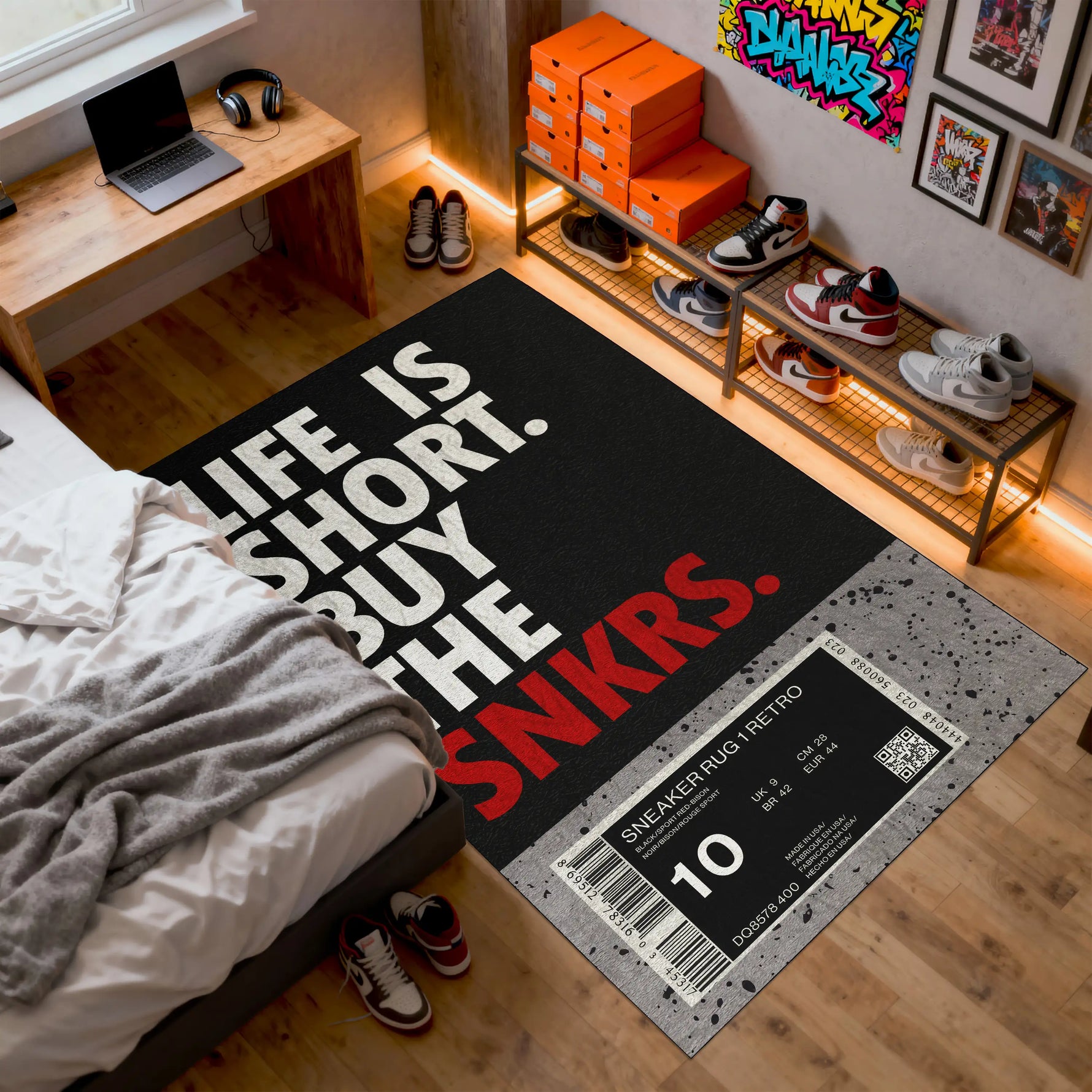 Room with a black rug featuring text and a sneaker-themed design, surrounded by shoes and a bed.

