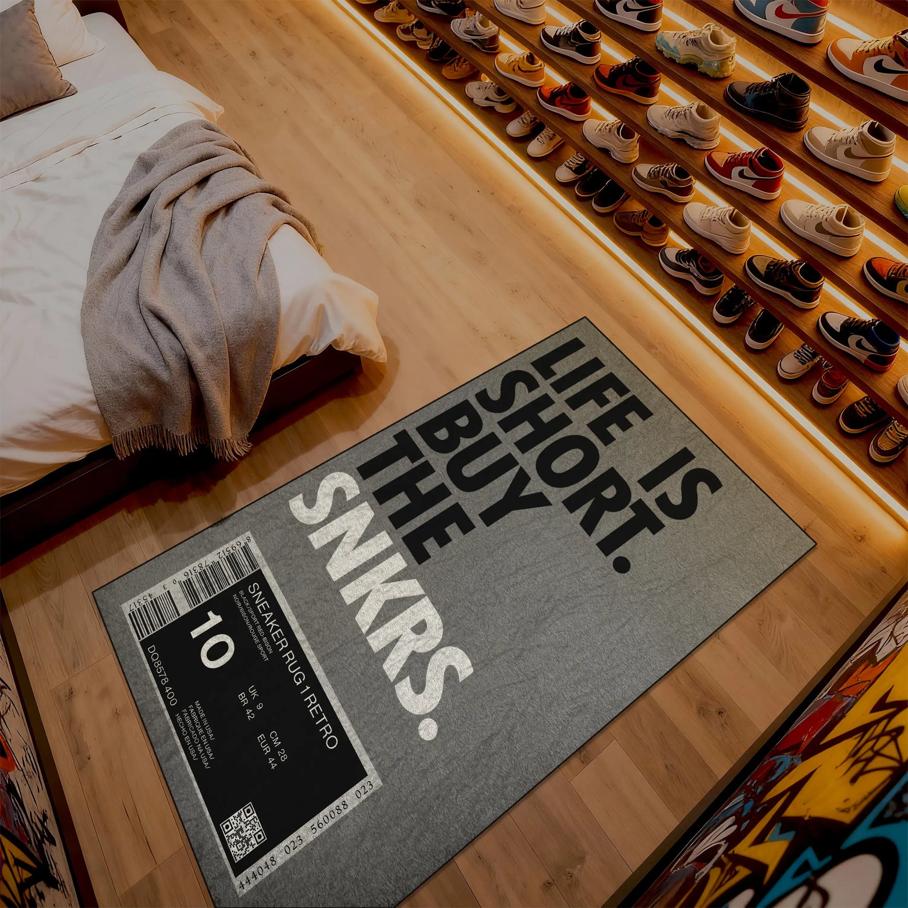 Gray doormat with 'Life is short, buy the SNKRS' text on a wooden floor.

