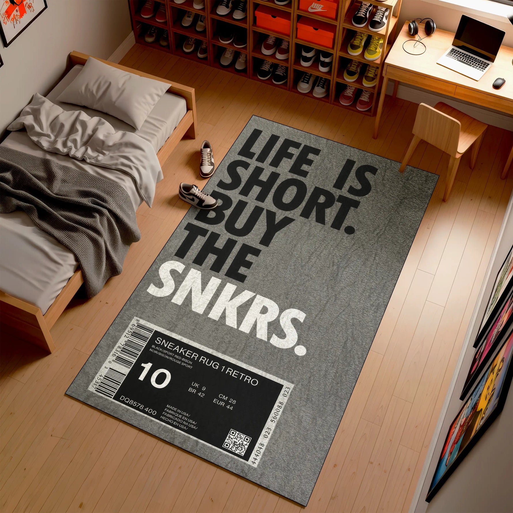 Gray rug with 'Life is Short, Buy the Snkrs' text in a room with a bed and desk.

