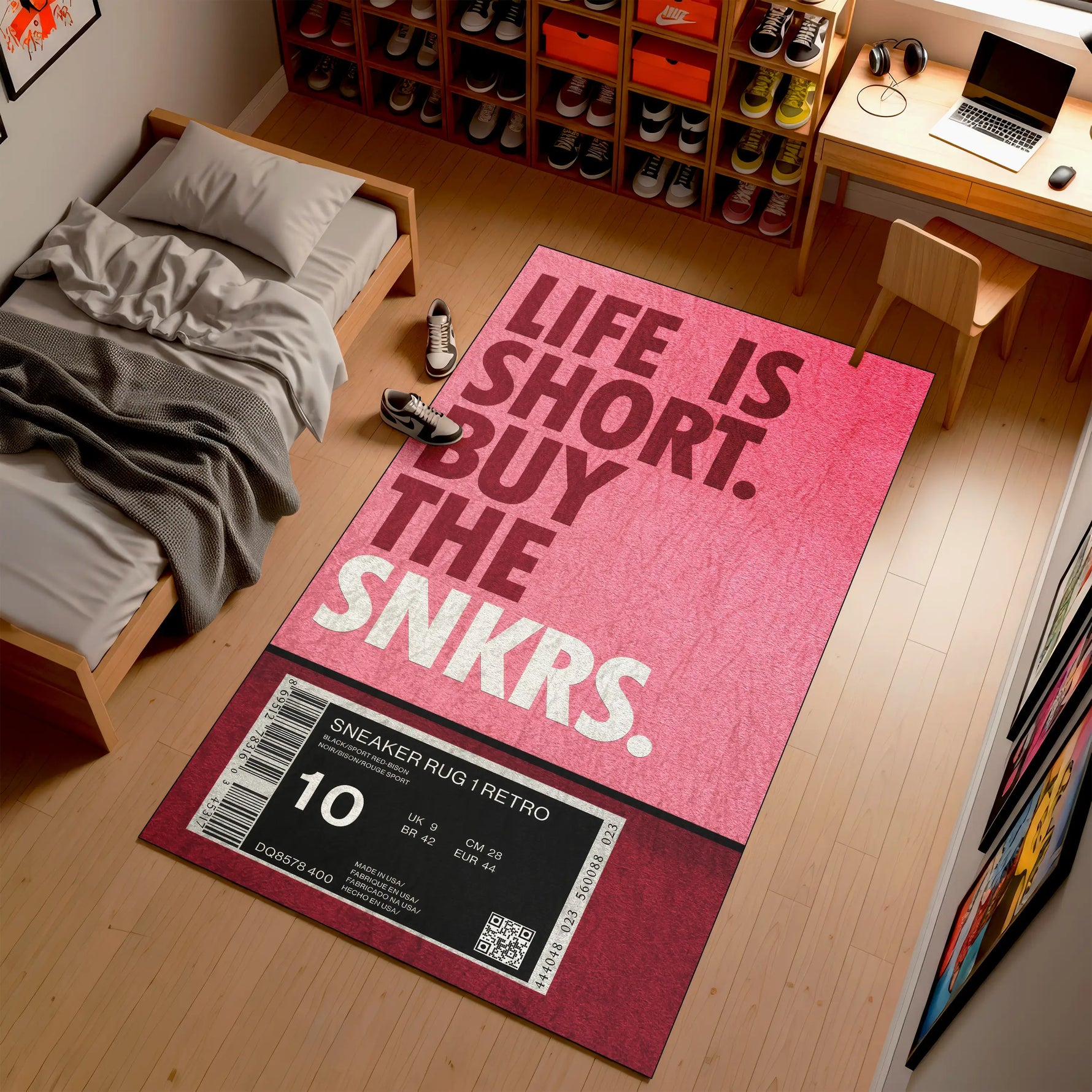 Pink rug with 'Life is Short, Buy the Snkrs' text in a room with a bed and desk.

