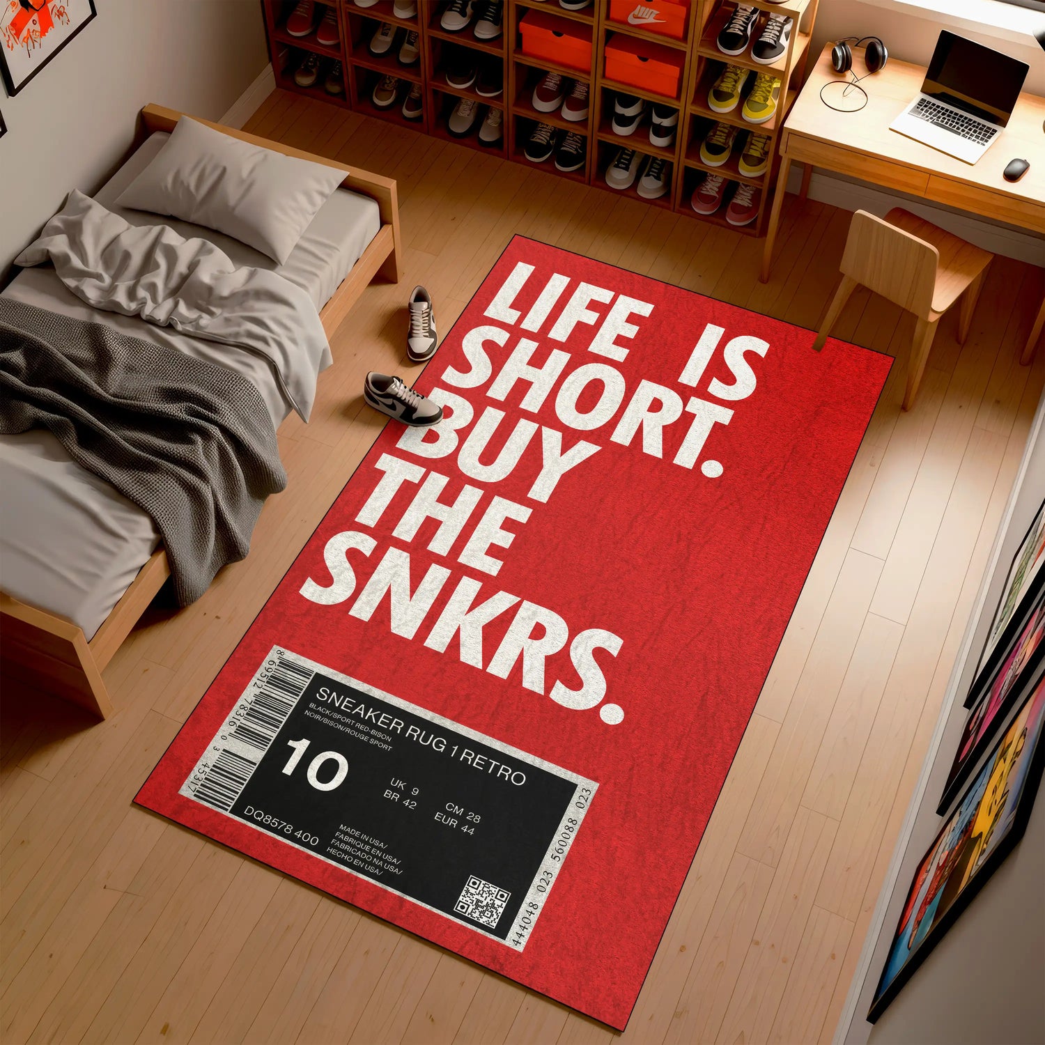 Red rug with 'Life is Short, Buy the Snkrs' text in a room with a bed and desk.

