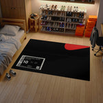 Black rug with a sneaker store label on a wooden floor, surrounded by shoes and shelves.


