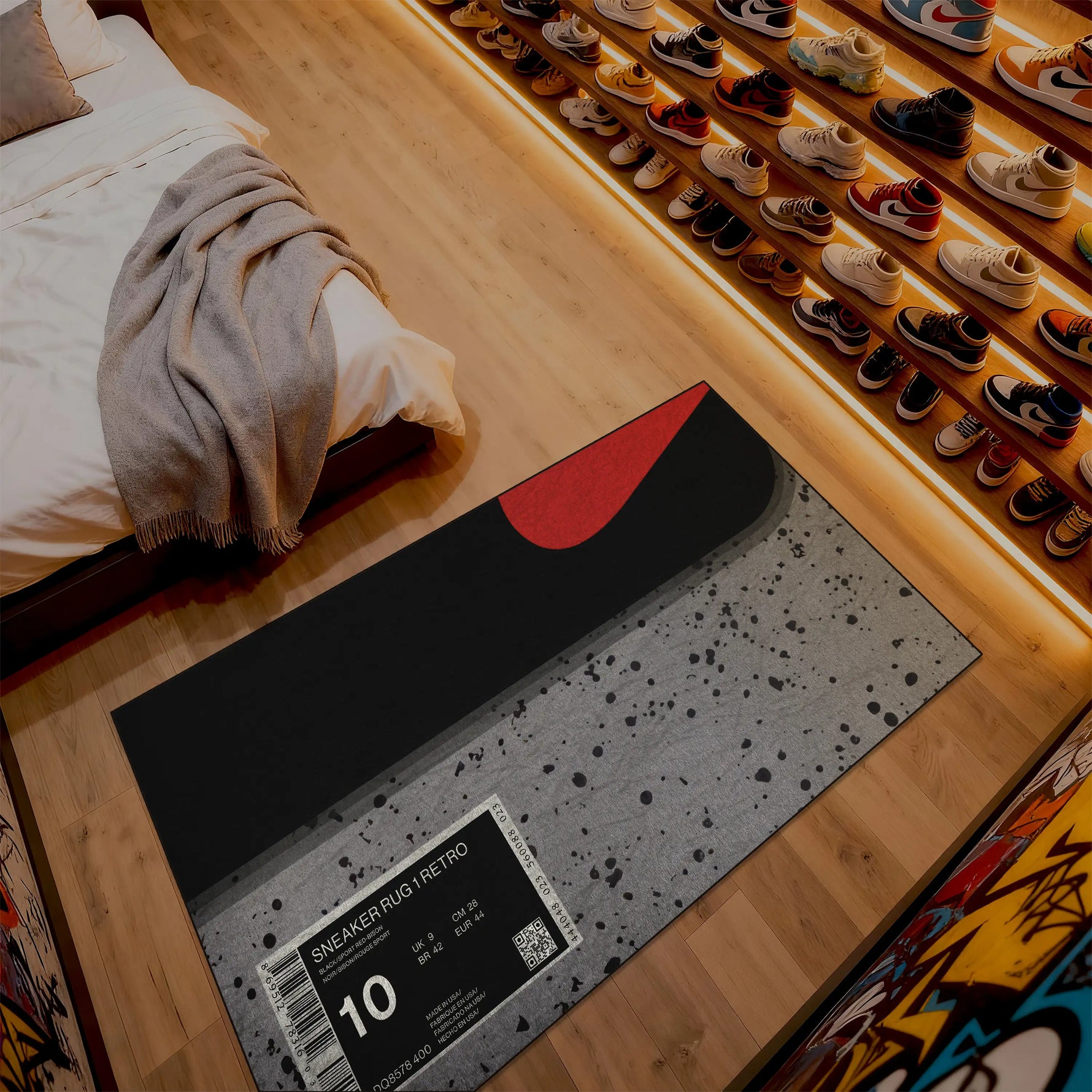 Gray speckled rug with a red circle on a wooden floor next to a bed.

