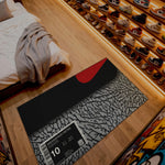 Shoe display with a rug labeled 'Sneaker Rug Nettto' on a wooden floor.

