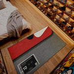 Shoe display with a red and gray rug featuring a sneaker design and size label.

