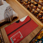 Red mat with a size label on a wooden floor next to a shoe display

