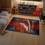 Colorful rug with a shoe design on a wooden floor in a room with shelves of shoes.

