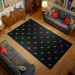 Living room with a black rug featuring colorful triangle patterns