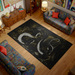 Living room with a large black rug featuring a white dragon design, colorful couches, and wooden furniture.