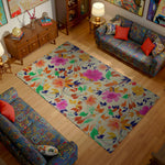 Living room with floral rug, colorful couches, and decorative items.
