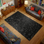 Living room with a black stone-patterned rug, colorful couches, and decorative items.