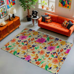 Living room with a colorful floral rug, orange sofa, and decorative items.