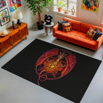 Living room with an orange sofa, black rug with a central design, and decorative items.