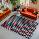 Living room with a geometric patterned rug, orange sofa, and decorative items.