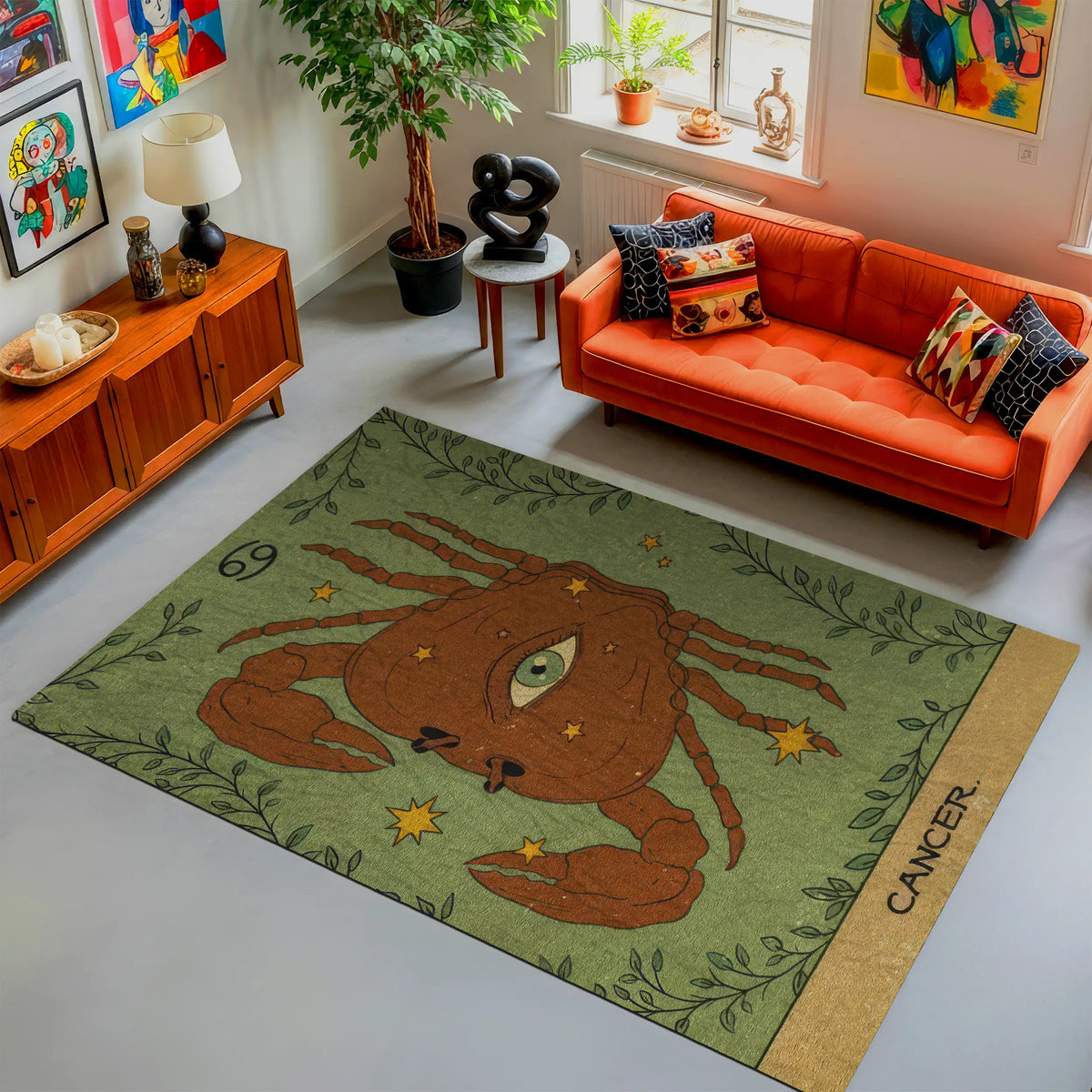 Living room with an orange sofa and a decorative rug featuring a crab design.