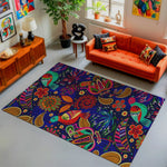 Living room with a colorful patterned rug, orange sofa, and decorative items.