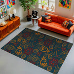 Living room with an orange sofa, decorative rug, and colorful artwork.
