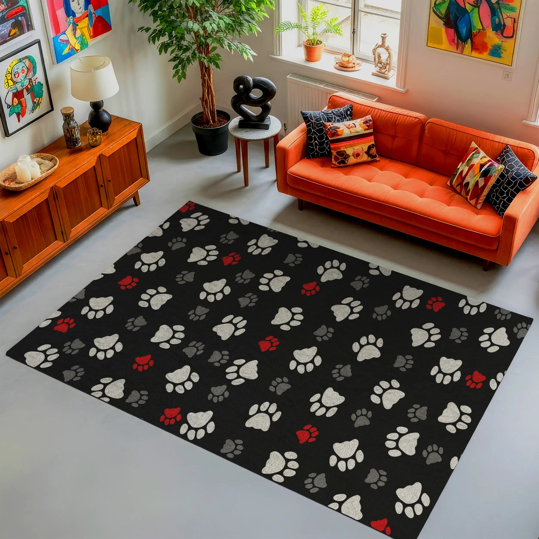 Living room with an orange sofa, colorful pillows, and a black rug with paw prints.