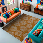 Living room with orange and teal sofas, colorful pillows, and a floral-patterned rug.
