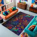 Colorful living room with a patterned rug, orange and teal sofas, and decorative items.