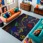 Colorful living room with a large abstract rug, orange and teal sofas, and decorative items.