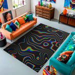 Colorful living room with a black and rainbow rug, orange and blue sofas, and decorative items.