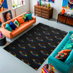 Living room with a black rug featuring rainbow designs, colorful couches, and decorative items.