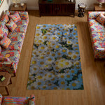 Floral rug on a wooden floor with colorful furniture in a living room setting