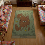 Decorative rug with a crab design and 'Cancer' text in a living room.