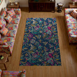 Colorful patterned rug on a wooden floor with floral and abstract designs, surrounded by colorful furniture.