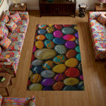 Colorful rug with stone pattern in a living room with floral sofas.