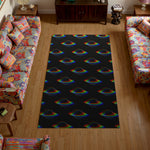 Living room with a colorful rug featuring rainbow patterns on a black background